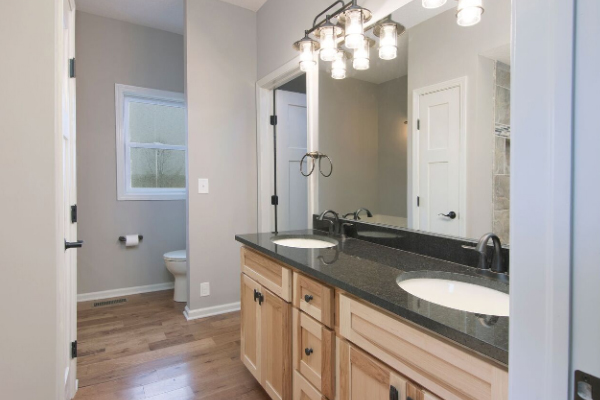 bathroom with double sink vanity and large mirror