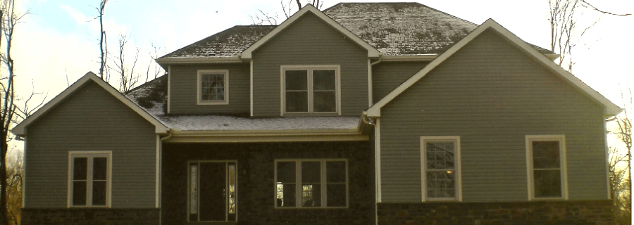 dark green vinyl siding with stone footer